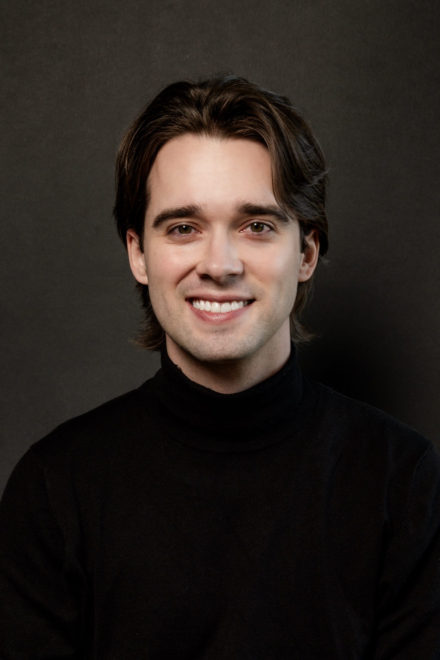 Headshot, smiling, black turtleneck